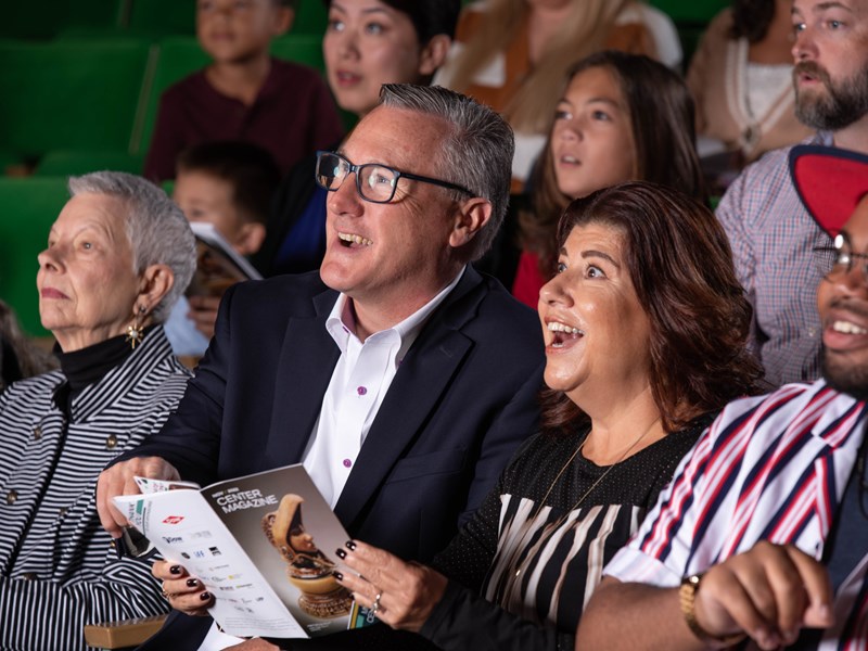 Couple in green auditorium seats