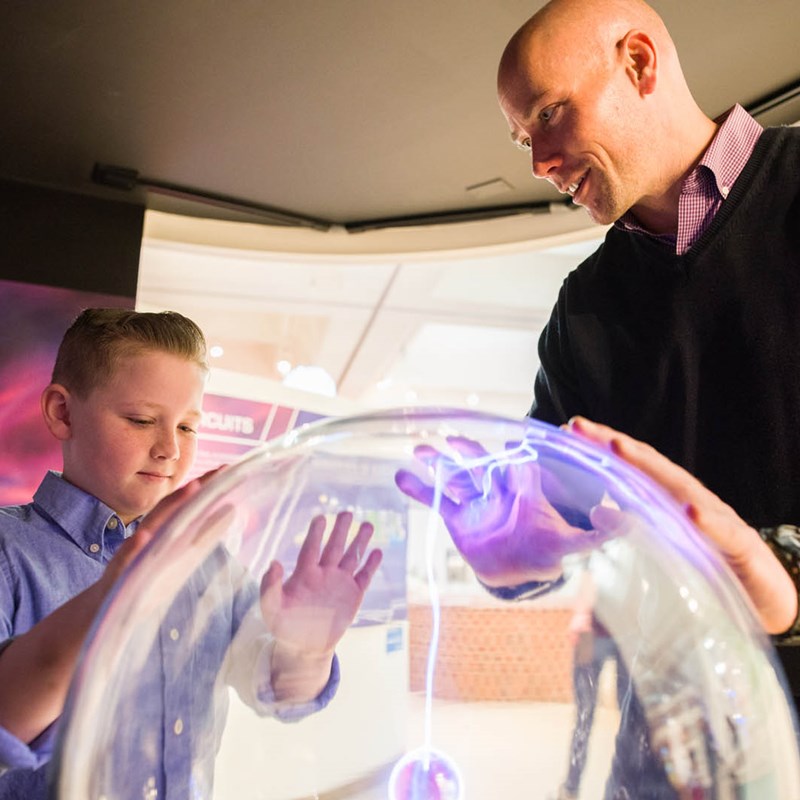 Kid and parent interacting with Exhibit
