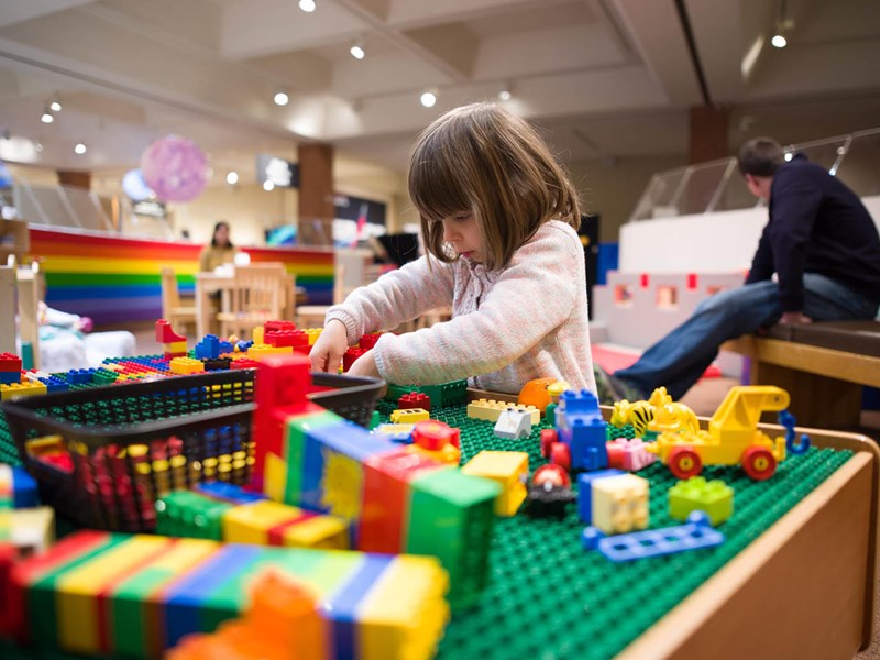 Girl building with blocks in the museum